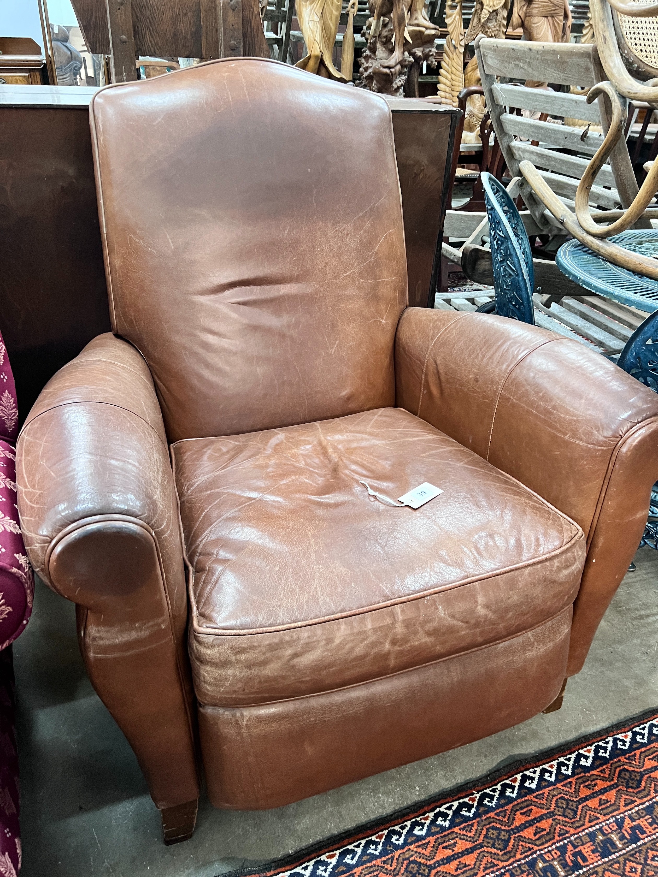 A contemporary tan leather reclining armchair with integral footrest, width 92cm, height 104cm *Please note the sale commences at 9am.